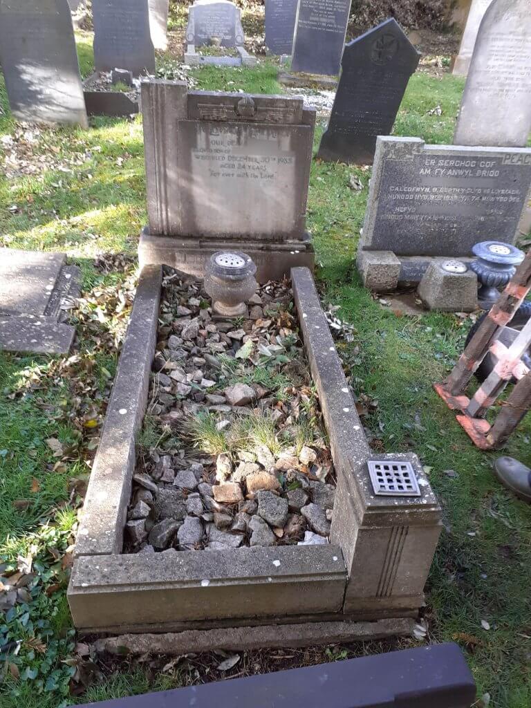 Headstone with Kerbs affected by weather erosion