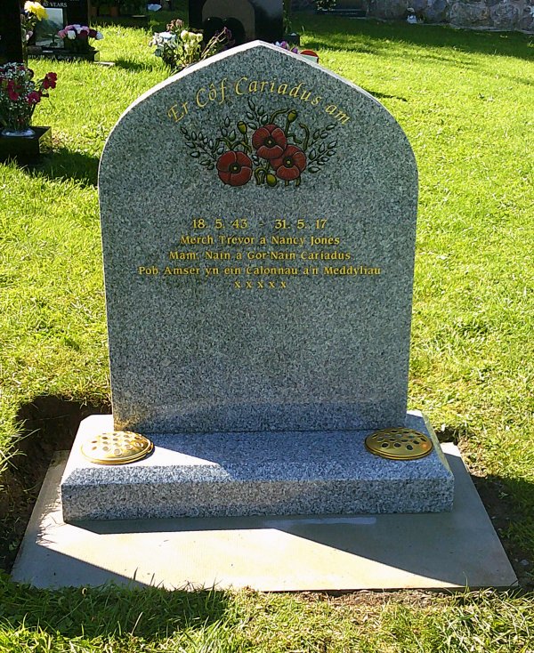 The Carlton memorial headstone in a gothic finish with hand painted red flowers and leaves