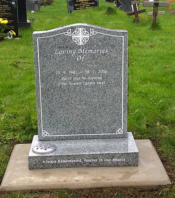 The Saddle with cross design memorial headstone and features