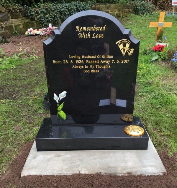 The colby memorial headstone with hand painted lillies and darts laser etching