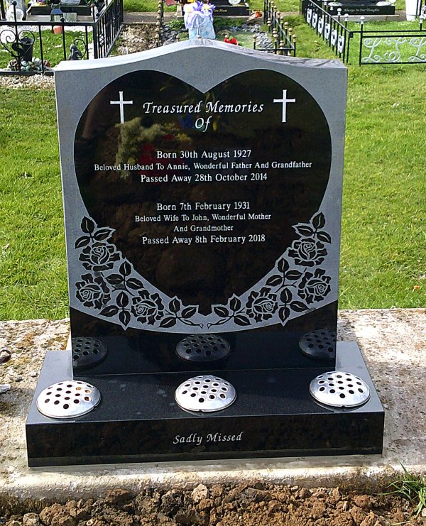The Saddle memorial headstone with heart and rose carvings