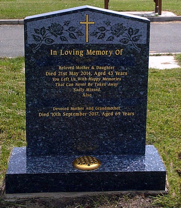 The Peon memorial headstone with blasted roses and gold cross hand painted